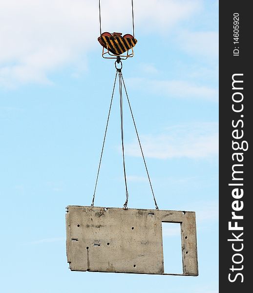 The image of concrete block lifted by tower crane