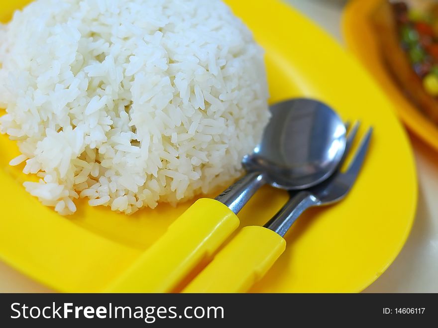 White rice with vegetable dishes in background. Rice is the stable diet in most Asian countries. For diet and nutrition, healthy eating and lifestyle concepts. White rice with vegetable dishes in background. Rice is the stable diet in most Asian countries. For diet and nutrition, healthy eating and lifestyle concepts.