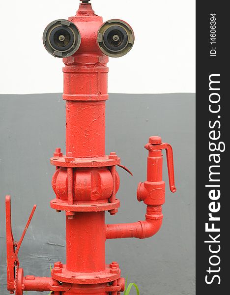 Red fire main tube looks like a big eyed robot.