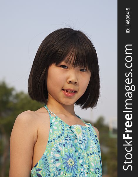 The outdoor portrait of an asian girl
