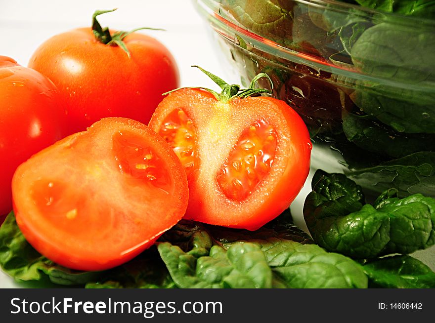 Tomatoes with spinach in a glass bowl