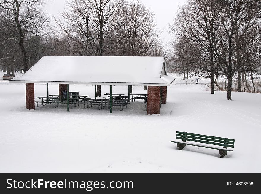 An empty park during snowfall. An empty park during snowfall.