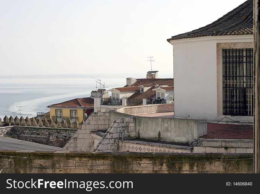 View of red-tiled roofs with the river tagus in the background. View of red-tiled roofs with the river tagus in the background