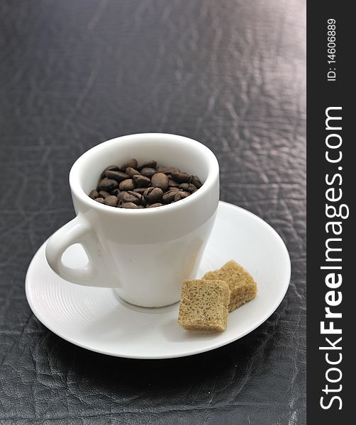 Coffee beans in the coffee cup, with 2 cube sugars. Coffee beans in the coffee cup, with 2 cube sugars