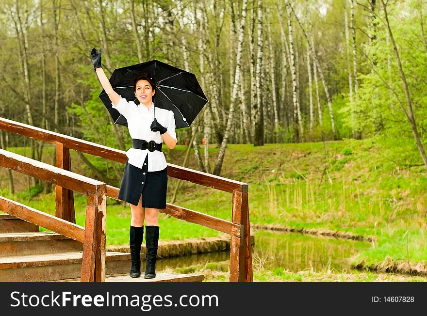 Young smiling woman waving hand in park. Young smiling woman waving hand in park