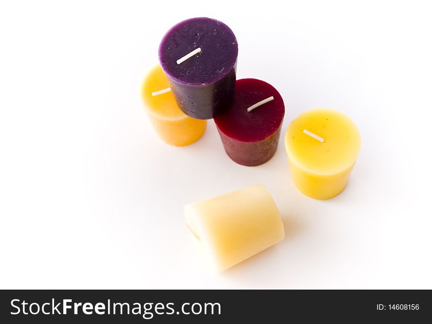 Colored wax candles on a white background, top view. Colored wax candles on a white background, top view
