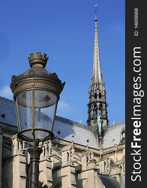 Paris street lamp against blue sky with Notre Dame Cathedral in background. Paris street lamp against blue sky with Notre Dame Cathedral in background