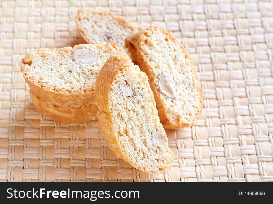 Stack of tasty almond biscotti cookies on woven placemat. Stack of tasty almond biscotti cookies on woven placemat