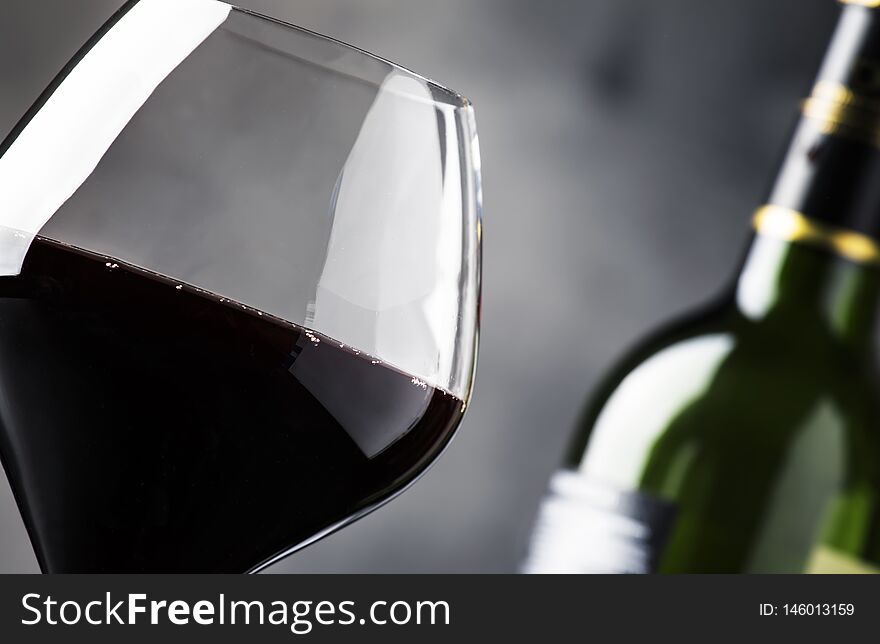 Red wine in wine glass, autumn still life with red and yellow leaves, wine tasting, copy space, selective focus