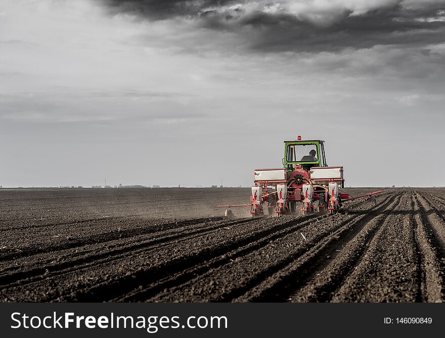 Sowing crops at agricultural fields in spring