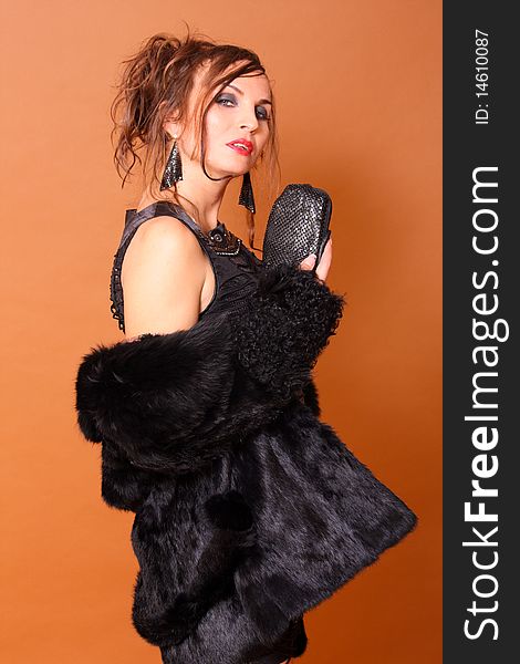 Beautiful fashion model with purse commercial expression