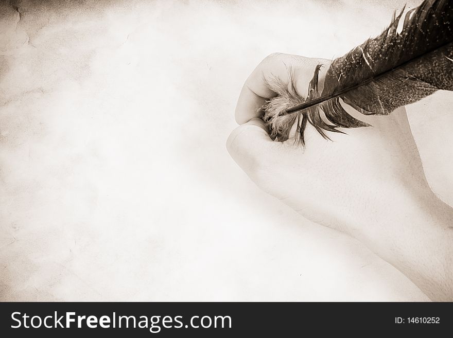 Vintage image of male hand holding the feather. Vintage image of male hand holding the feather