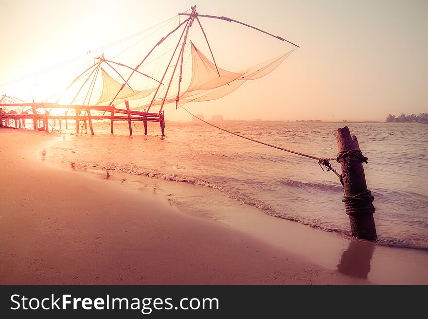 Amazing sunset colors of tropical beach. Ocean coast landscape with chinese fishing nets silhouette at Cochin Kochi. South India, Kerala, Kochin. Amazing sunset colors of tropical beach. Ocean coast landscape with chinese fishing nets silhouette at Cochin Kochi. South India, Kerala, Kochin