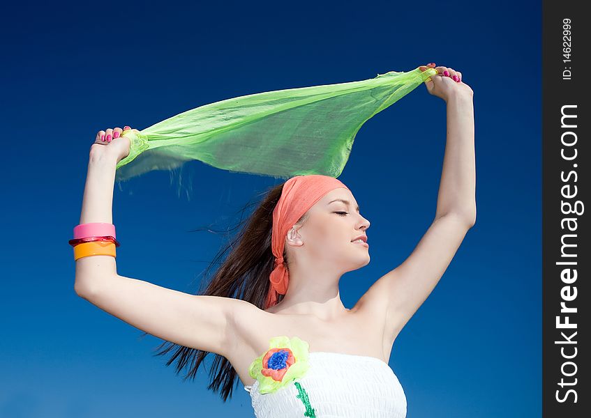 Beautiful girl with kerchief on blue background