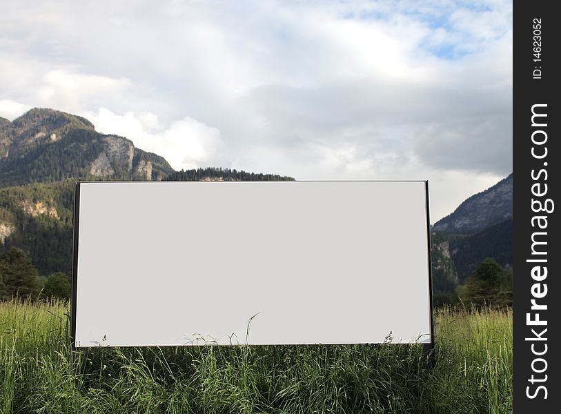 Advertising billboard with mountains on the background
