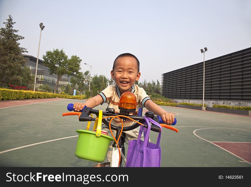 The asian boy is riding the bike with great fun. The asian boy is riding the bike with great fun