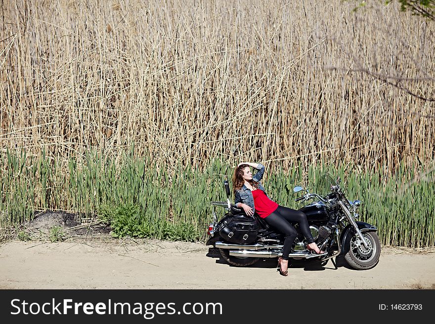 Portrait of a young girl on a motorcycle