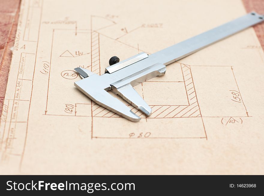 Workplace: Engineer drawing and  caliper