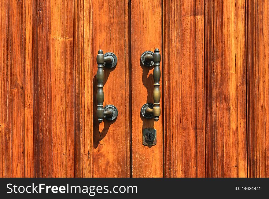 Photo of part of wood door with iron handle