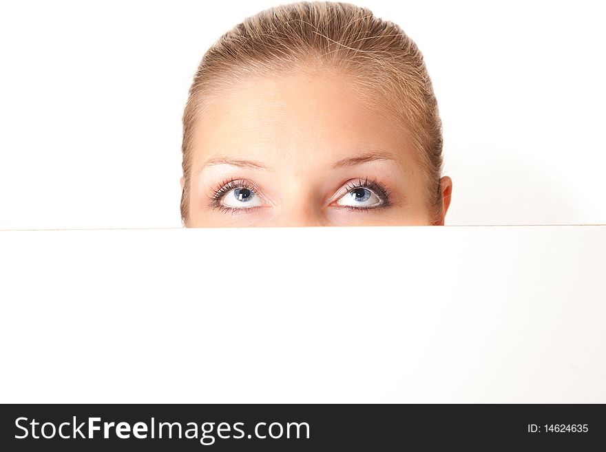 Woman peeping from behind white board