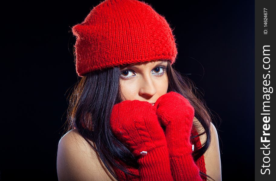 Close-up beautiful face of young woman with red hat and mitten