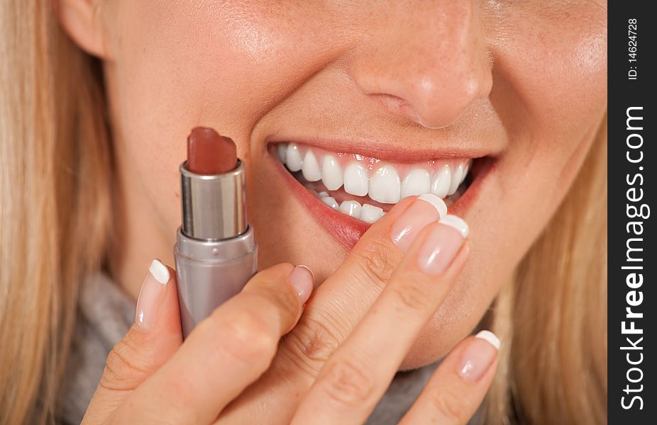 Woman with lipstick on white background closeup