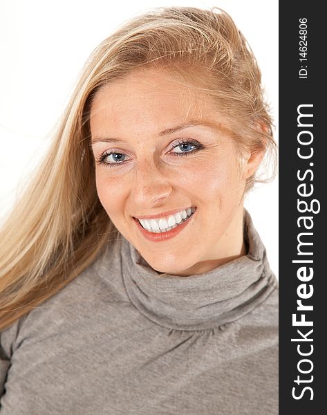 Caucasian blond girl portrait in gray outfit on white background smiling