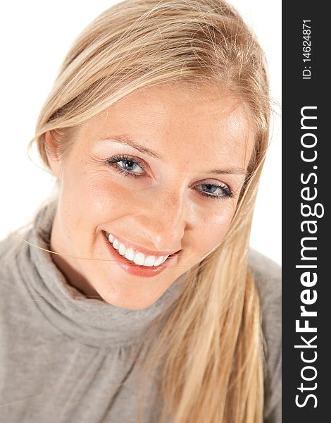 Caucasian blond girl portrait in gray outfit on white background smiling