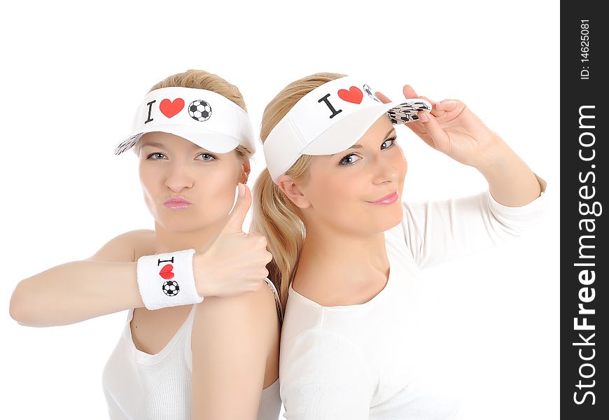 Two pretty football fan girls in funny hats. isolated on white background