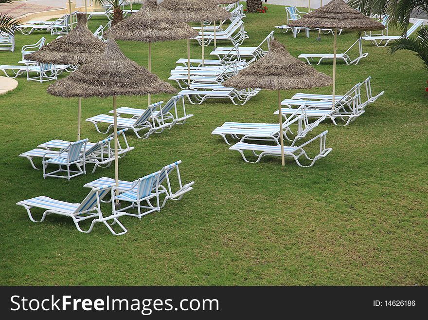 Pool chair in a tropical resort garden