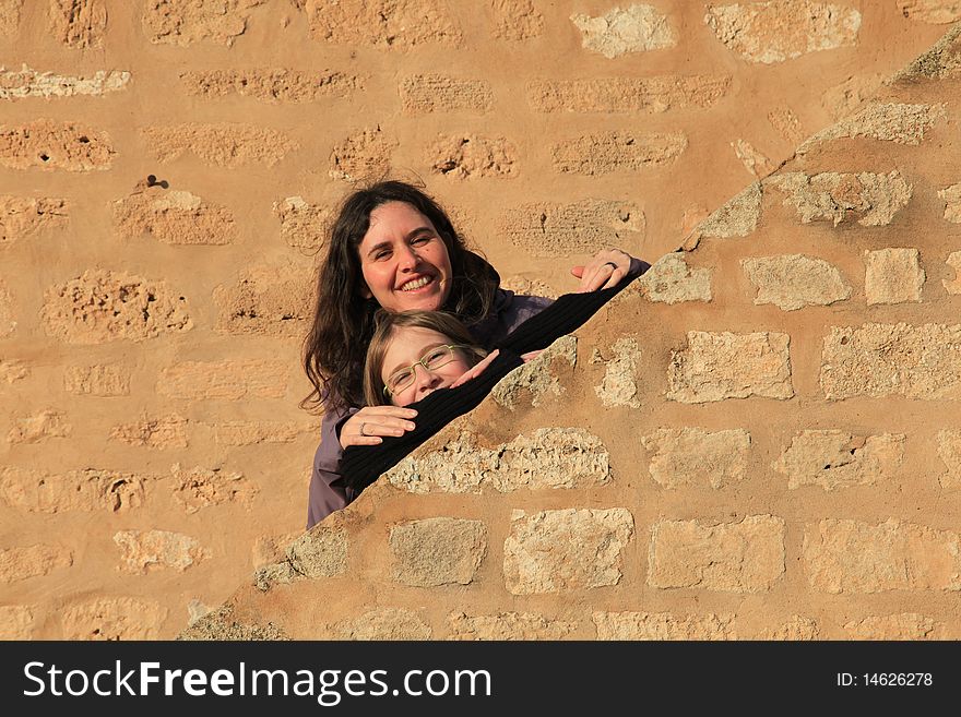 Woman and daughter on ancient stone walls