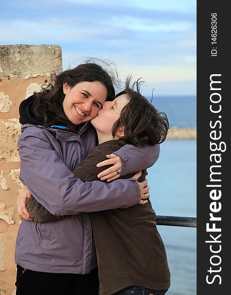 Son kissing mother in an tourist old stone castle