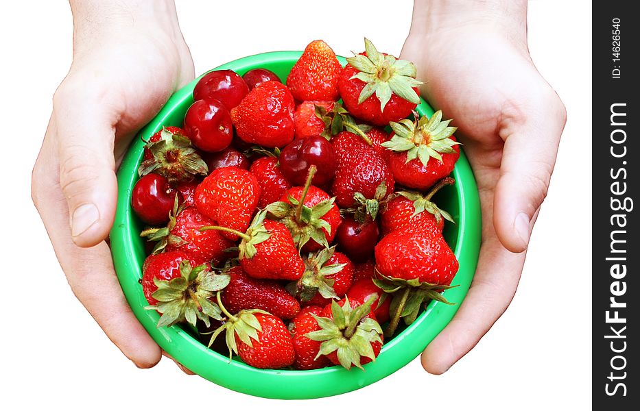 Mans hands keeping green plate with a strawberry