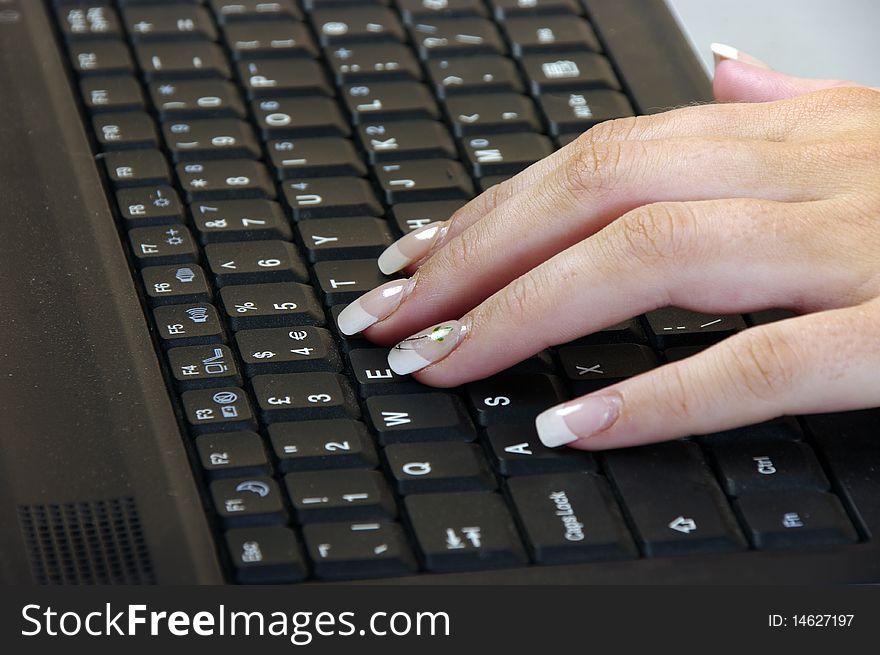 Girls hand working on a keyboard. Girls hand working on a keyboard