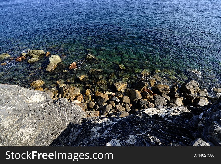 The sea near a beach. It is a sunny day. The sea near a beach. It is a sunny day.