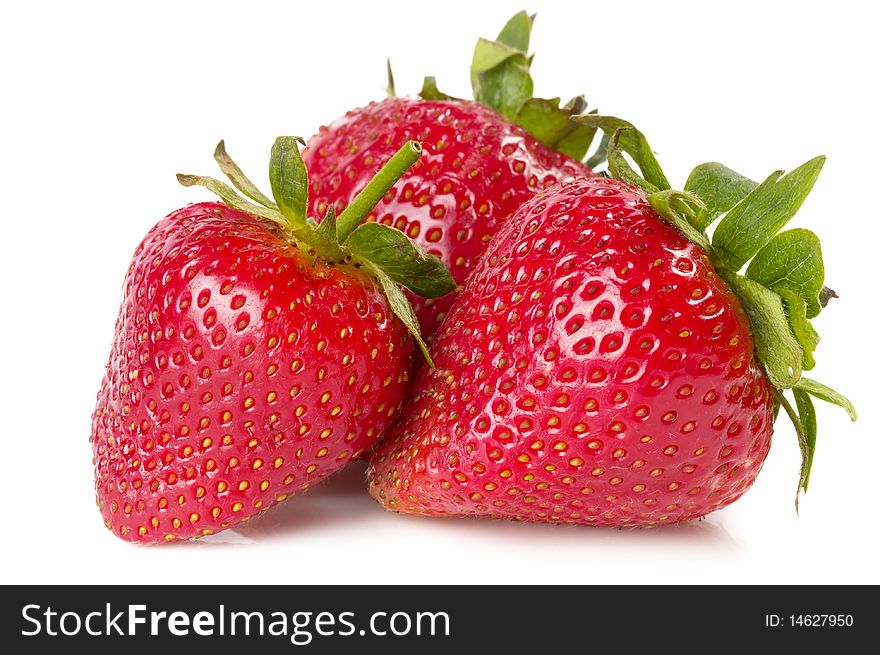 Three strawberries macro shot isolated over white background