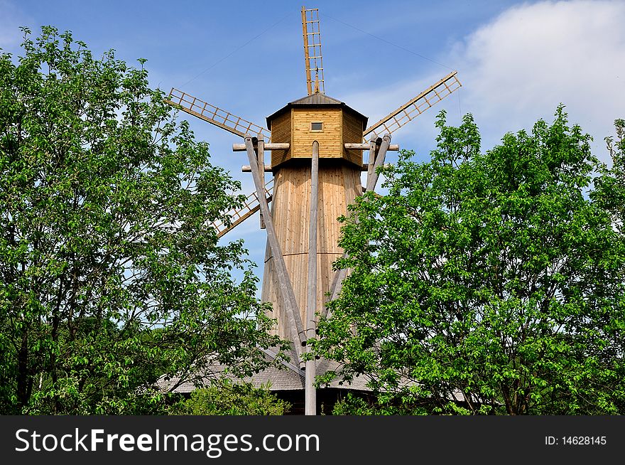 Old windmill among trees. Summer. Old windmill among trees. Summer.