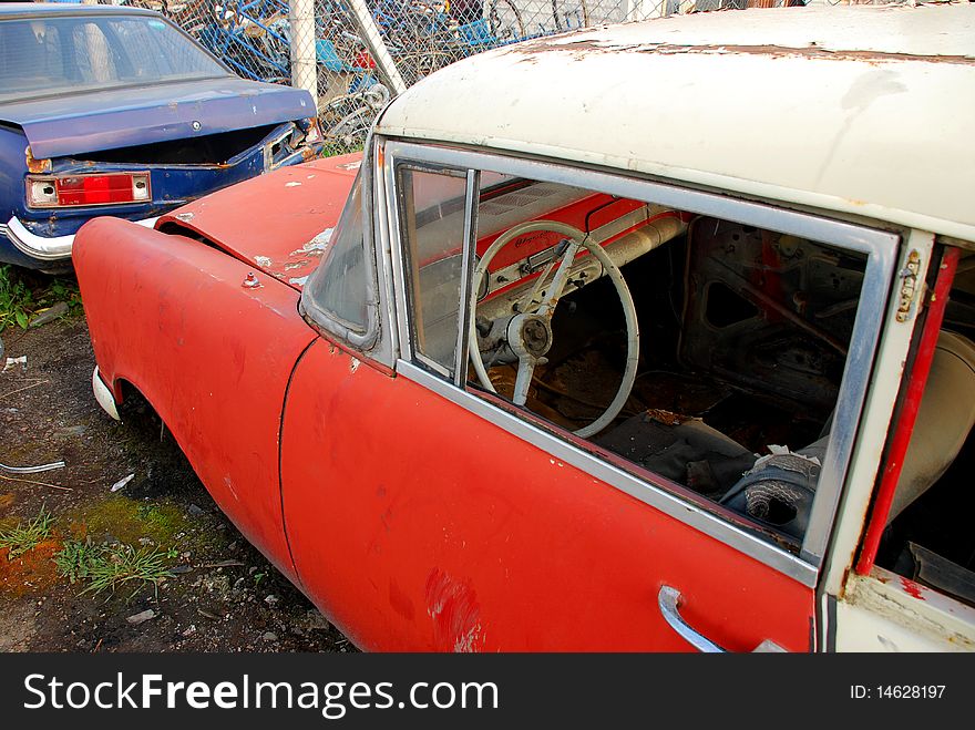 Old rusted American car and junked car. Old rusted American car and junked car