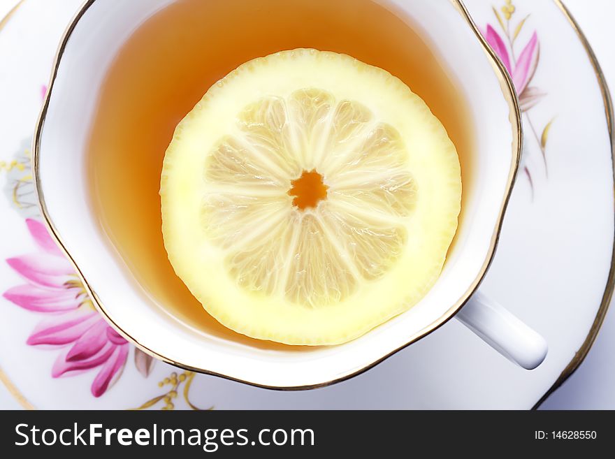 Refreshing cup of herbal tea with slice of lemon floating on top. Refreshing cup of herbal tea with slice of lemon floating on top