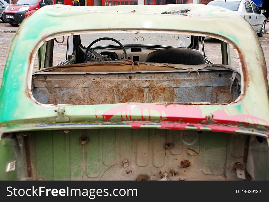 Back of a old abandoned car with broken window. Back of a old abandoned car with broken window.