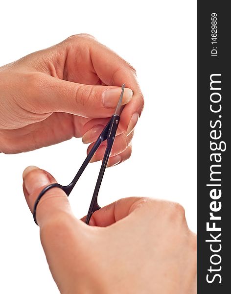 Cosmetic scissors in woman's hand. studio shot