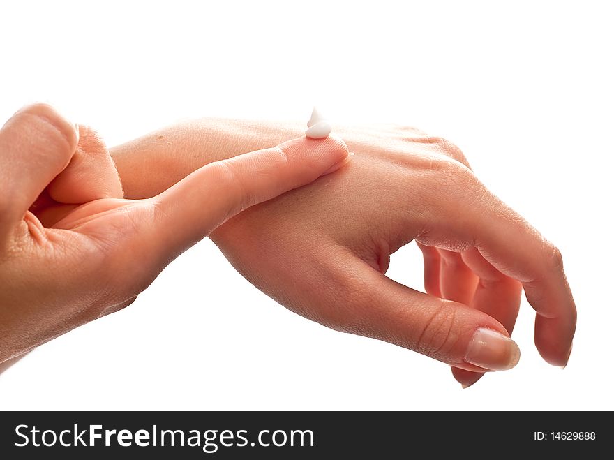 Cream on woman's hand. Isolated on white background. Cream on woman's hand. Isolated on white background