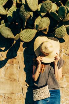 Woman Near A Stone Fence With Cacti Royalty Free Stock Photo