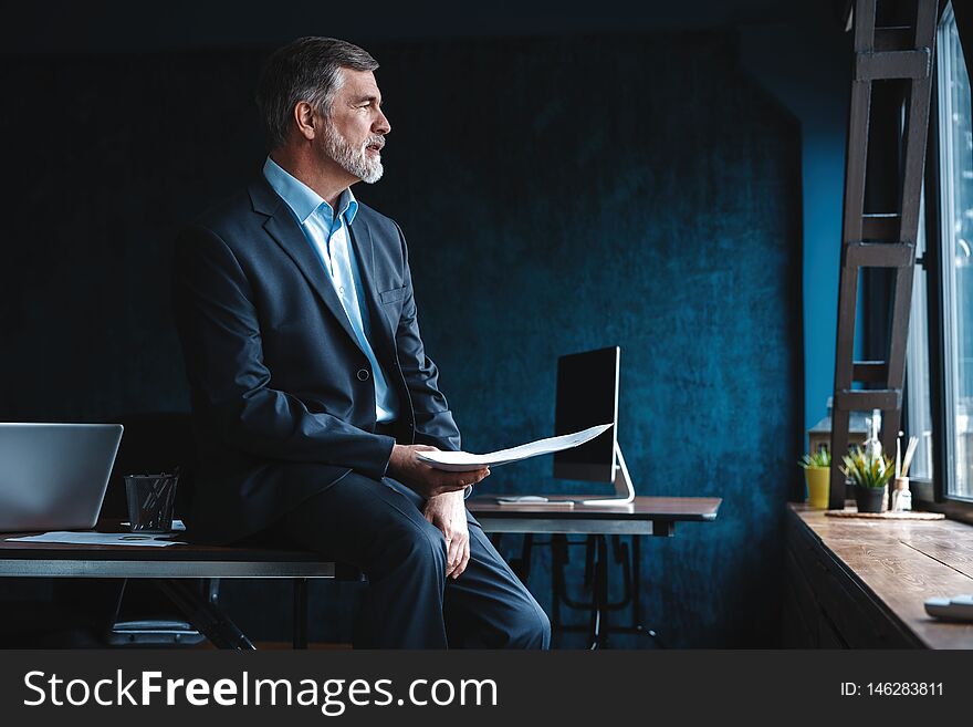 Confident Pensive Mature Business Man In Modern Office.