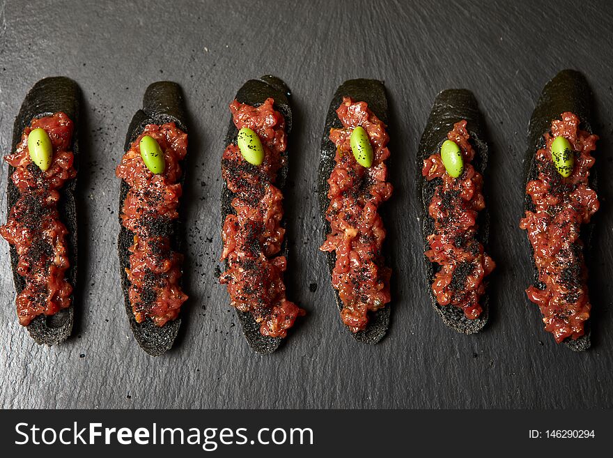 Bruschetta on black stone serving board. Bruschetta on black stone serving board