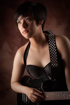 Attractive Multiethnic Girl Plays Her Guitar Royalty Free Stock Photography Attractive Multiethnic Girl Plays Her Guitar Royalty Free Stock Photography