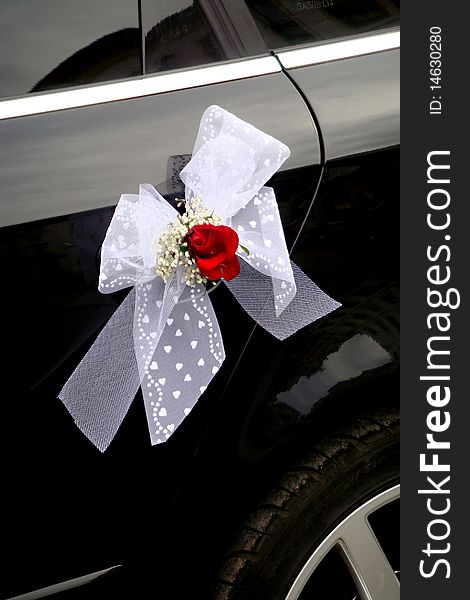 White ribbon on just married car