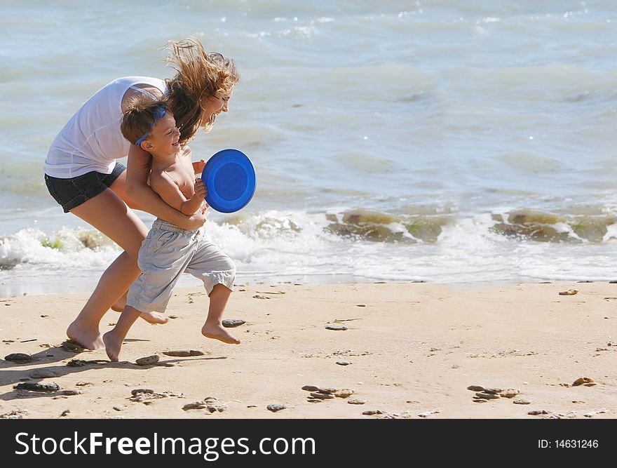 Happy Mother And Son On Beach