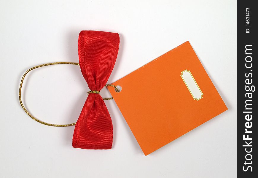 Red bow on a gold lace with a yellow label. Red bow on a gold lace with a yellow label.