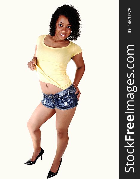 An very pretty young Hispanic woman standing in the studio in high heels,
jeans shorts and yellow t-shirt, smiling with her black curly hair, over white. An very pretty young Hispanic woman standing in the studio in high heels,
jeans shorts and yellow t-shirt, smiling with her black curly hair, over white.